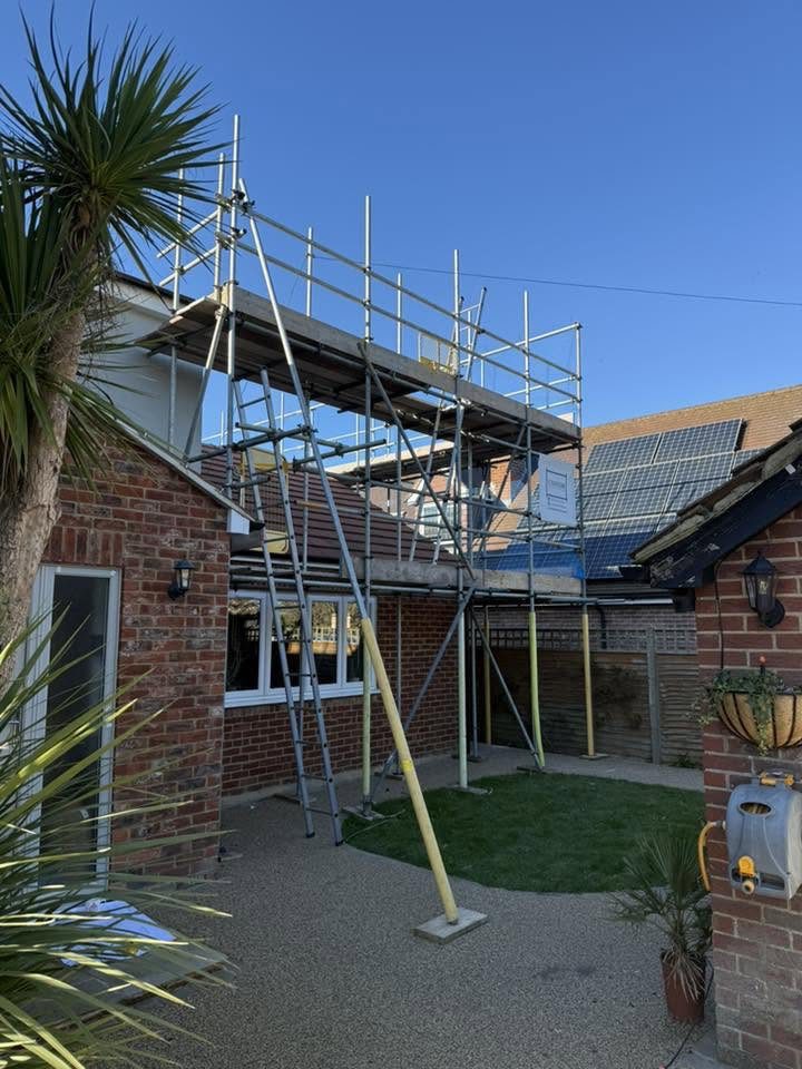 Extension scaffold beside a solar roof in Kent