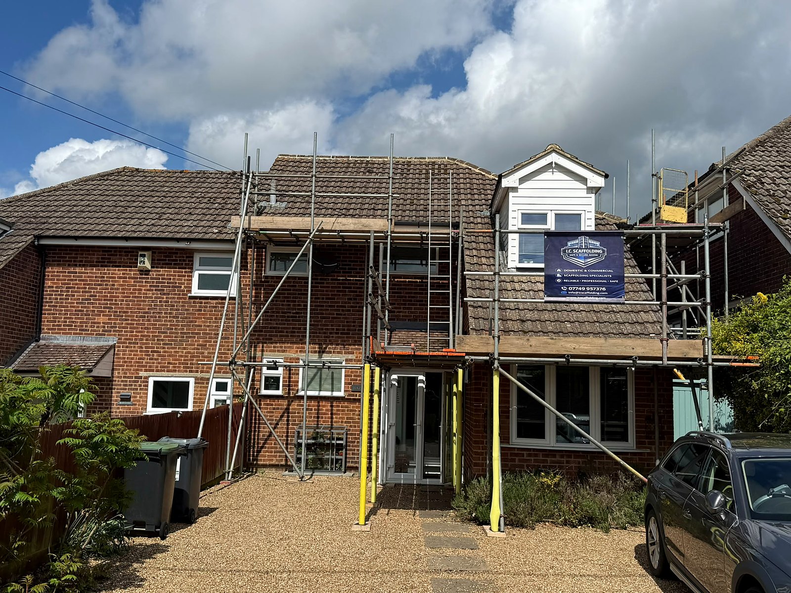 Full rear-elevation wrap scaffold on a brick family home in Kent, every lift boarded and braced