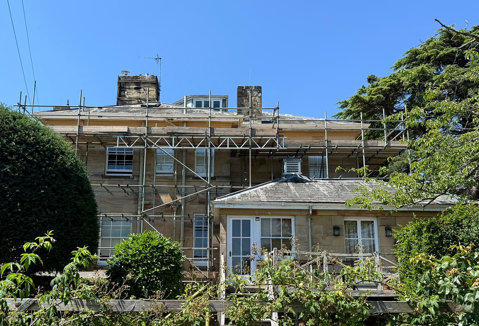 Period manor in the Kent Weald under full-elevation access scaffold